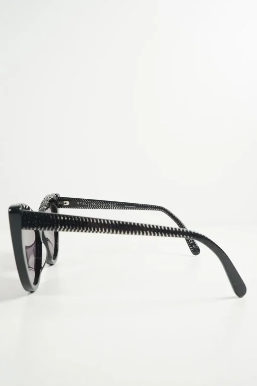 Black bio-acetate cat eye sunglasses with silver chain and shimmer details