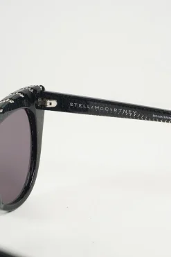 Black bio-acetate cat eye sunglasses with silver chain and shimmer details