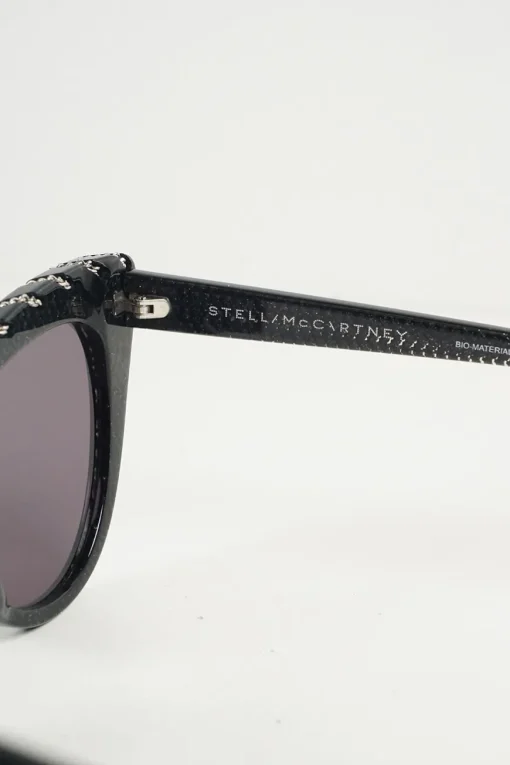 Black bio-acetate cat eye sunglasses with silver chain and shimmer details
