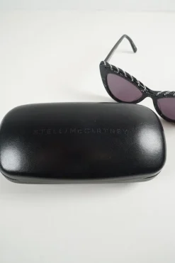 Black bio-acetate cat eye sunglasses with silver chain and shimmer details