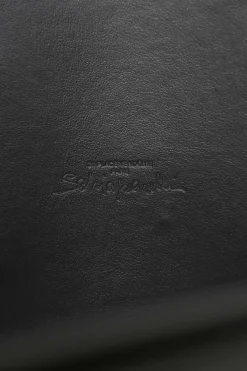Black box calfskin and gold-finish metal ear belt featuring original Jean Schlumberger 1938 co-created house emblem earring