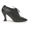 Black brogued leather pointed-toe lace-up Victorian-style heeled booties with metallic Coco Mark heel plaque appliqué