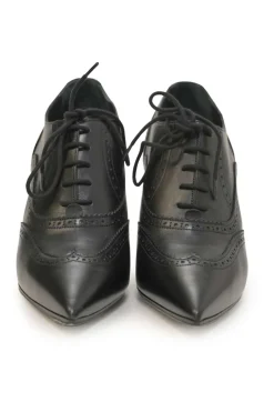 Black brogued leather pointed-toe lace-up Victorian-style heeled booties with metallic Coco Mark heel plaque appliqué