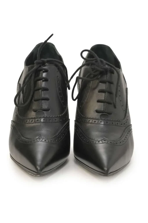 Black brogued leather pointed-toe lace-up Victorian-style heeled booties with metallic Coco Mark heel plaque appliqué