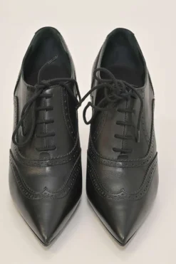 Black brogued leather pointed-toe lace-up Victorian-style heeled booties with metallic Coco Mark heel plaque appliqué