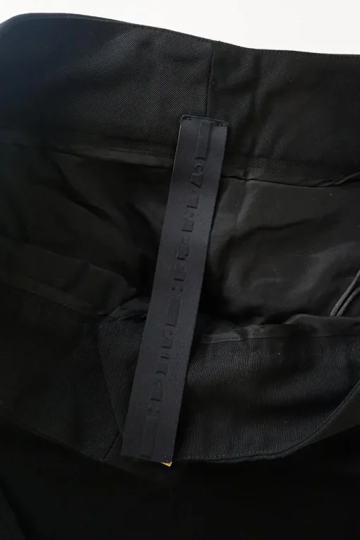 Black cotton low-rise flared tailored trousers with concealed bar and zip closure at front