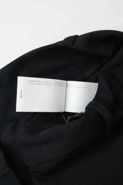 Black cotton low-rise flared tailored trousers with concealed bar and zip closure at front