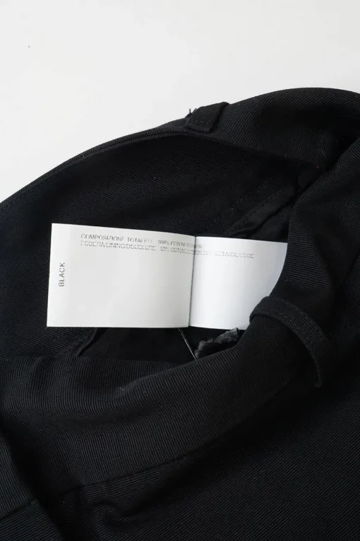 Black cotton low-rise flared tailored trousers with concealed bar and zip closure at front