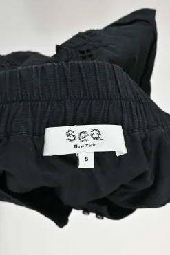 Black cotton-blend cotton broderie Anglaise button-front A-line skirt with scalloped hem