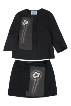 Black cotton-blend cropped swing jacket and wrap-front mini skirt set featuring floral patch appliqué