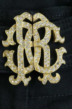 Black cotton-blend low-rise skinny jeans with crystal-embellished logo buckle fastening