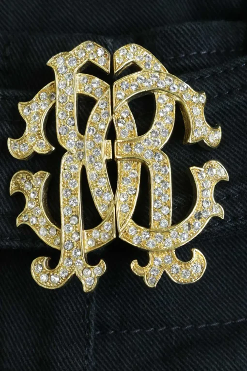 Black cotton-blend low-rise skinny jeans with crystal-embellished logo buckle fastening