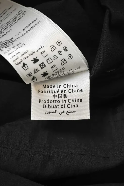 Black cotton-blend satin point collar half-button slip-on coverall jumpsuit with pull tab belt at waist
