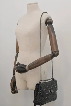 Black crinkle leather Rockstud spike crossbody flap bag with gunmetal hardware