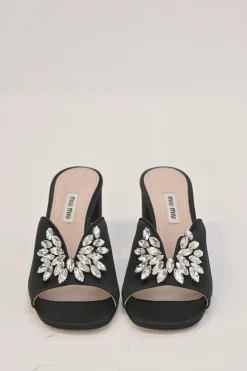 Black crystal-embellished satin and leather block heel mules with curved V-neck vamp