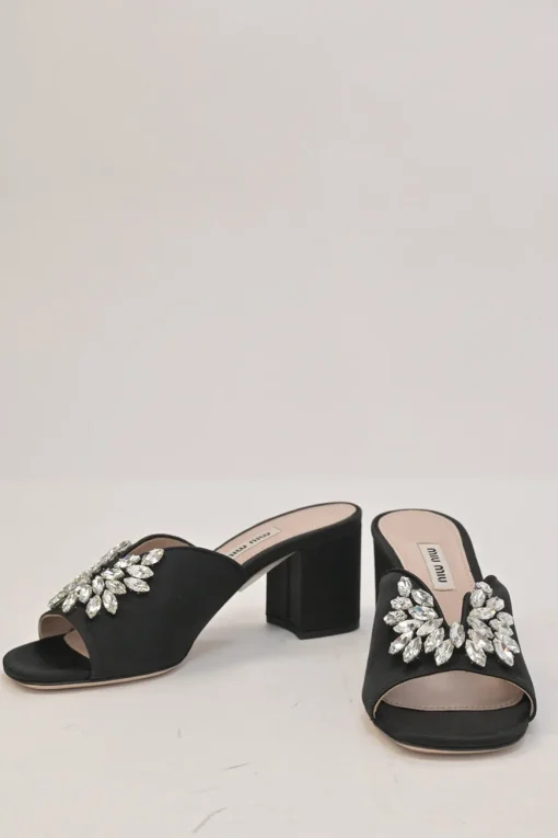 Black crystal-embellished satin and leather block heel mules with curved V-neck vamp