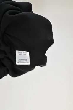 Black draped silk stand collar open-front cardigan with button loop fastening at centre front