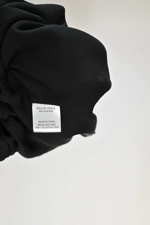 Black draped silk stand collar open-front cardigan with button loop fastening at centre front