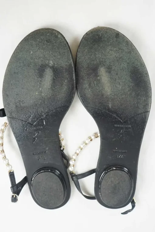 Black faux-pearl embellished leather thong sandals with adjustable buckle ankle strap