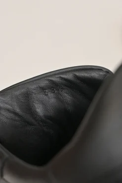 Black leather and rubber low-top Day sneakers with palladium-plated Kelly buckle mid-arch strap