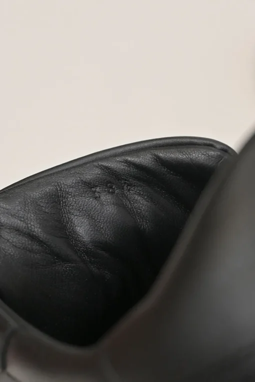 Black leather and rubber low-top Day sneakers with palladium-plated Kelly buckle mid-arch strap