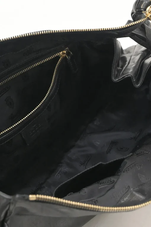Black leather Hystetria zip pouch featuring gold-tone metallic medallion appliqué