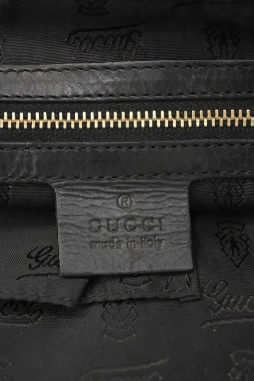 Black leather Hystetria zip pouch featuring gold-tone metallic medallion appliqué