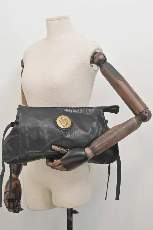 Black leather Hystetria zip pouch featuring gold-tone metallic medallion appliqué