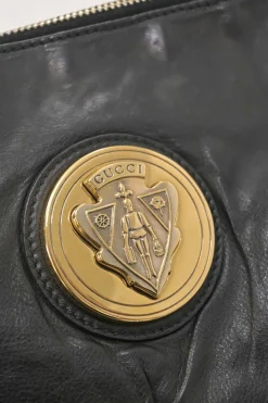 Black leather Hystetria zip pouch featuring gold-tone metallic medallion appliqué