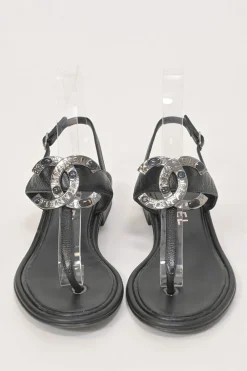 Black leather slingback thong sandals featuring cabochon Coco Mark logo plaque
