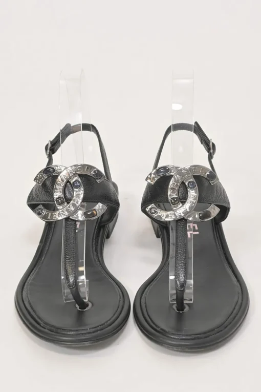 Black leather slingback thong sandals featuring cabochon Coco Mark logo plaque