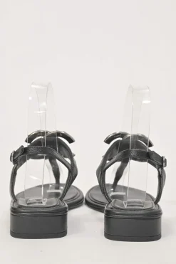 Black leather slingback thong sandals featuring cabochon Coco Mark logo plaque