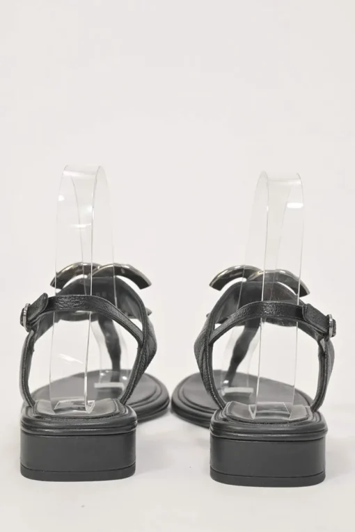 Black leather slingback thong sandals featuring cabochon Coco Mark logo plaque