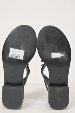 Black leather slingback thong sandals featuring cabochon Coco Mark logo plaque