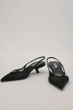 Black mesh, leather and rubber pointed-toe slingback kitten-heel pumps with metallic enamel logo vamp plaque