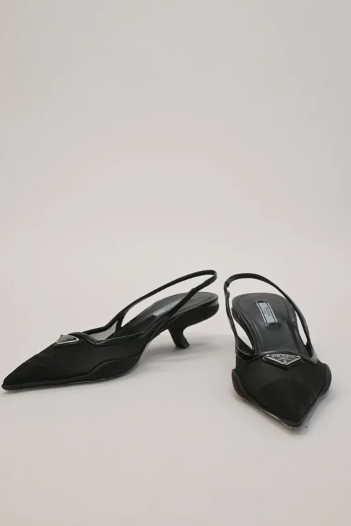 Black mesh, leather and rubber pointed-toe slingback kitten-heel pumps with metallic enamel logo vamp plaque