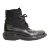 Black paneled fabric and leather lace-up mid-calf boots with rubber soles and webbing details