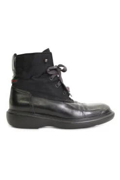 Black paneled fabric and leather lace-up mid-calf boots with rubber soles and webbing details