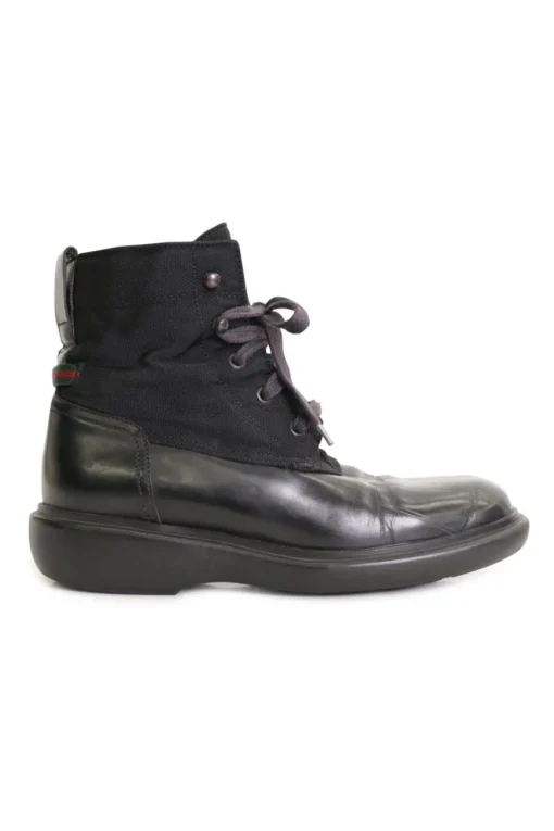 Black paneled fabric and leather lace-up mid-calf boots with rubber soles and webbing details