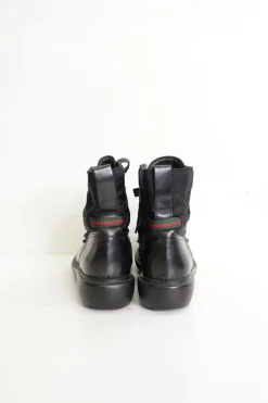 Black paneled fabric and leather lace-up mid-calf boots with rubber soles and webbing details