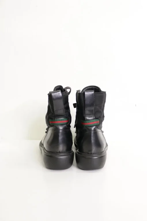 Black paneled fabric and leather lace-up mid-calf boots with rubber soles and webbing details