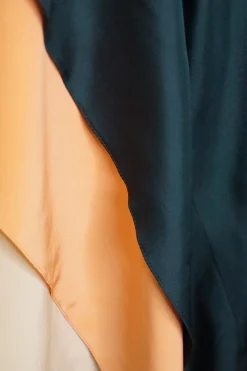 Black paneled silk asymmetric midi skirt with contrasting tiered satin hem inserts