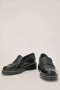 Black patent leather and calfskin round-toe penny-style pinked edge loafers with chainlink vamp appliqué