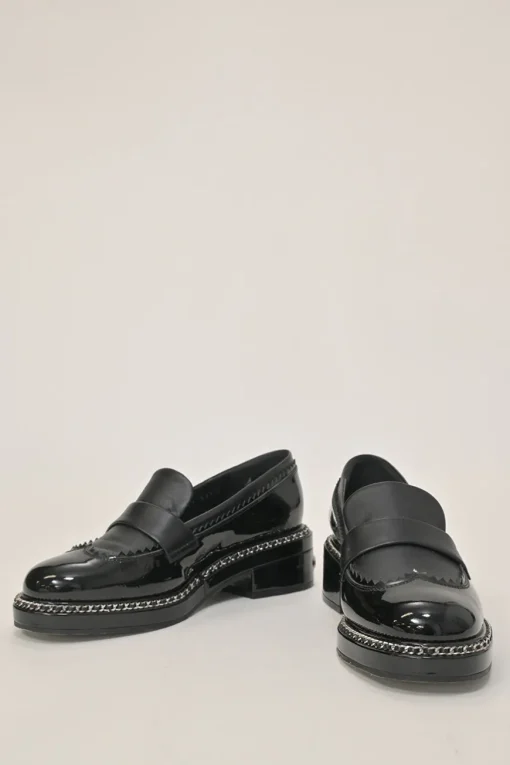 Black patent leather and calfskin round-toe penny-style pinked edge loafers with chainlink vamp appliqué