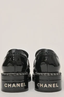 Black patent leather and calfskin round-toe penny-style pinked edge loafers with chainlink vamp appliqué