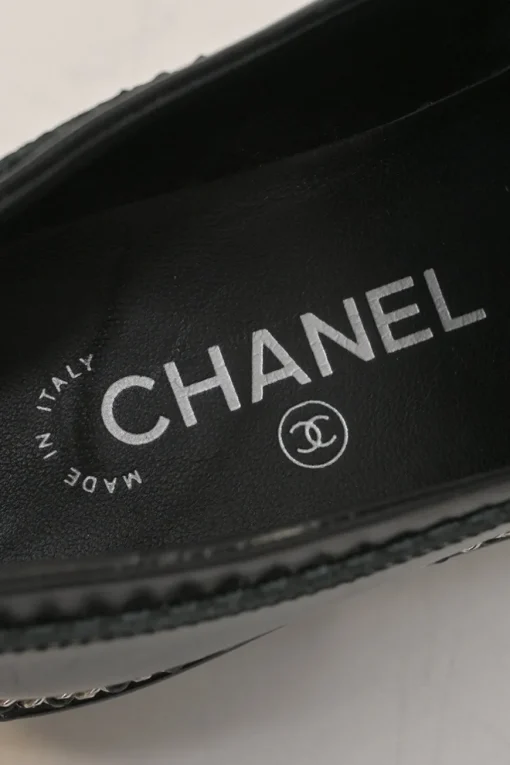 Black patent leather and calfskin round-toe penny-style pinked edge loafers with chainlink vamp appliqué