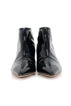 Black patent leather ankle boots with low silver heels.