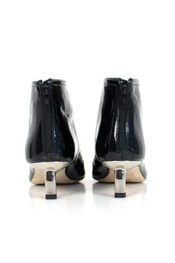 Black patent leather ankle boots with low silver heels.