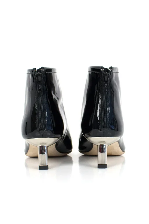 Black patent leather ankle boots with low silver heels.