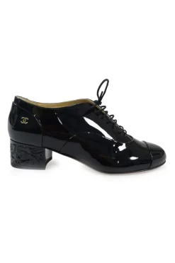 Black patent leather lace-up brogues with Coco Mark ankle plaque and sculpted camellia block heel